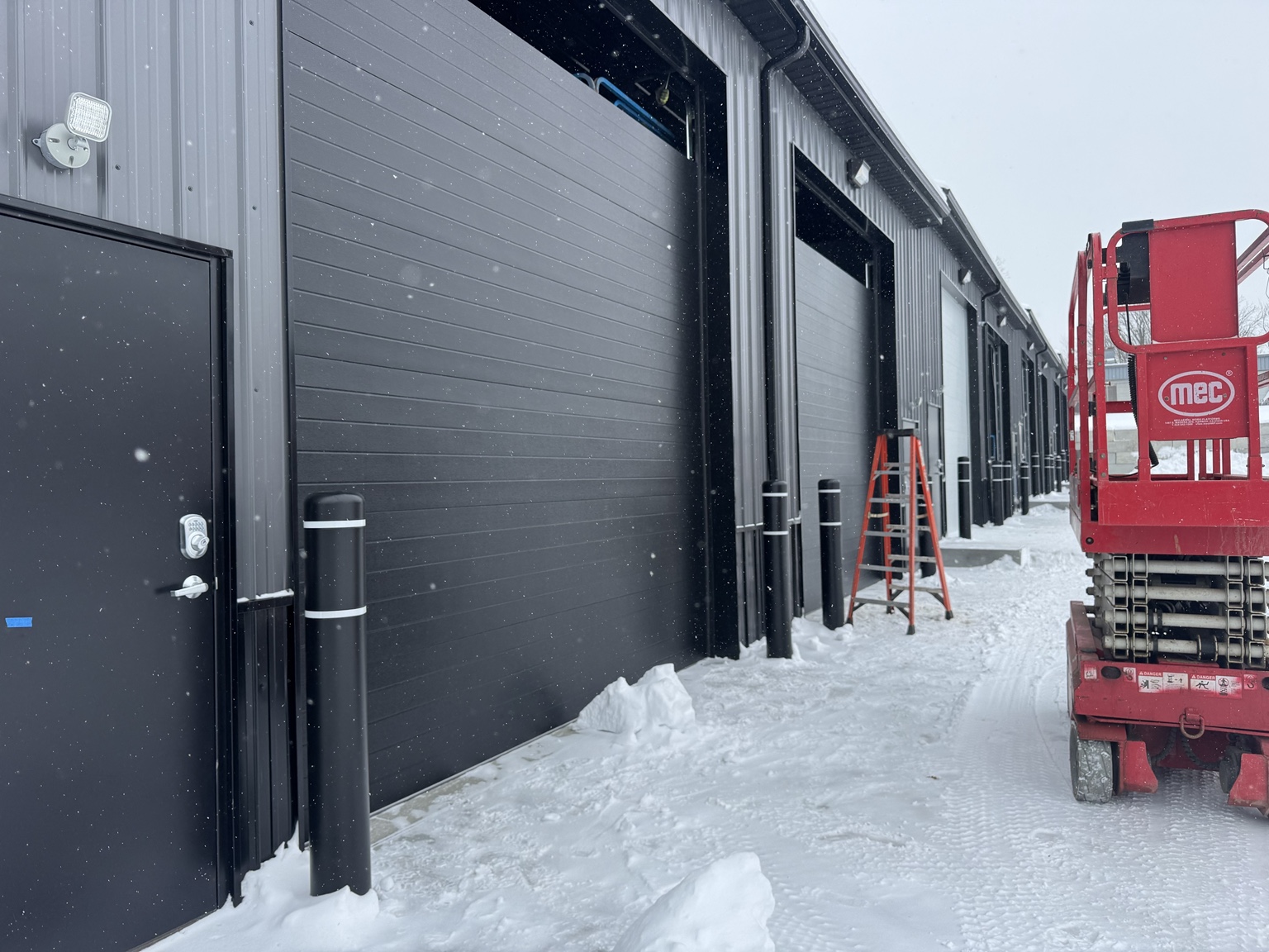 Commercial overhead door installation during final construction of PROFLEX in Akron Ohio