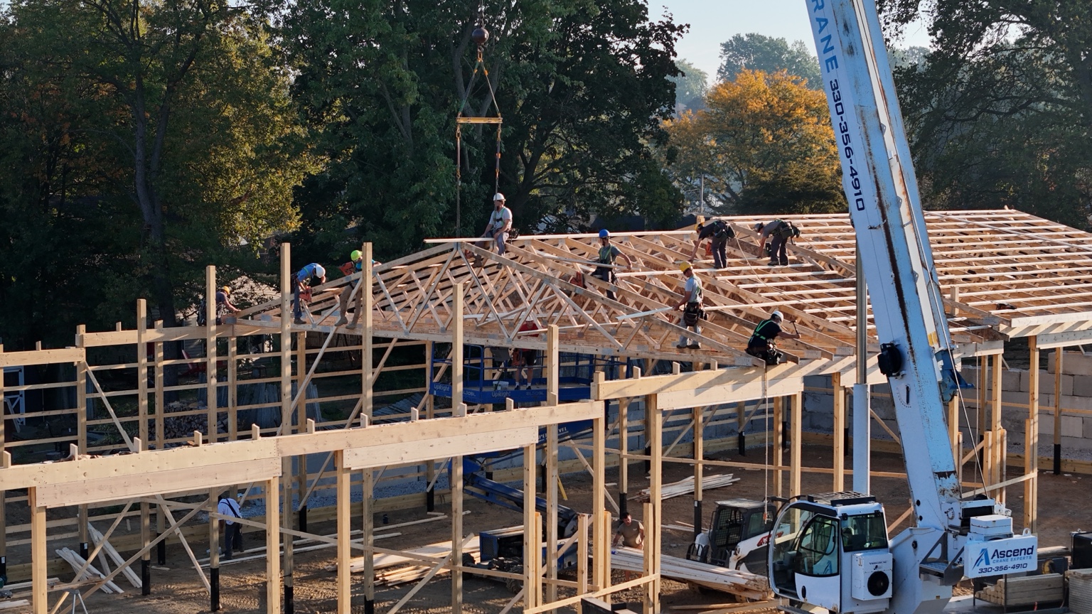 Crane setting roof trusses during construction of PROFLEX commercial garage space in Akron Ohio
